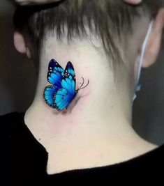 a woman with a blue butterfly tattoo on her neck