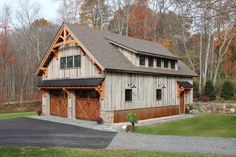 a two story garage with an attached porch