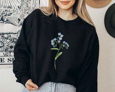 Our Forget me not Sweatshirt features a watercolor illustration of forget-me-nots. Original floral print by the artist that you won't find anywhere else. This botanical jumper will make a great keepsake for yourself, or a thoughtful gift for someone you know going through the grief of loss. Sweatshirts are 50% cotton, 50% polyester with a rib-knit collar and double-needle stitching. This cozy mid-weight jumper is perfect for autumn/winter. Unisex (boyfriend) fit - boxy and long. How it's made: * Spring Crew Neck Sweatshirt, Spring Crew Neck Sweatshirt For Gift, Crew Neck Sweatshirt For Spring, Spring Gift Long Sleeve Sweatshirt, Spring Long Sleeve Sweatshirt, Forget Me Nots Flowers, Flower Clothing, Forget Me Not Flower, Flower Sweatshirt