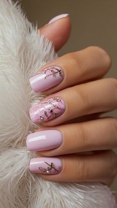 a woman's hand with pink and white nail polish