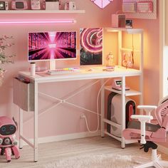 a desk with a computer monitor and pink chair