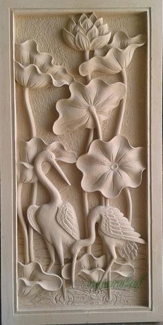 an intricately carved wall panel with flowers and birds