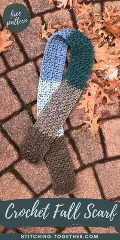 a crochet fall scarf laying on the ground with leaves around it and text overlay that reads, crochet fall scarf