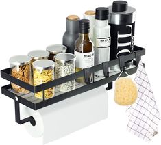 a black shelf with spices and other items on it next to a kitchen towel rack