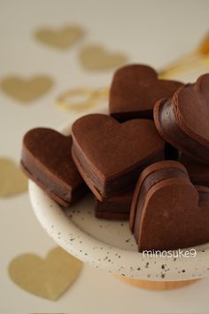 chocolate heart shaped cookies on a white plate