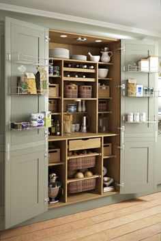 an open cabinet with baskets and other items in it