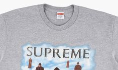 The Supreme Levitation Tee is a heather grey short sleeve graphic T-shirt from Supreme's Fall/Winter 2019 season that was inspired by an album cover for "Chants," which was written by the Benedictine Monks of Santo Domingo de Silos.  One of the more obscure references of the season, the front of the tee features several floating monks against a white cloud backdrop.  Rounding out the design are mismatched grey bricks that appear on the bottom of the graphic and grey Supreme branding on the top p Gray Band Merch T-shirt With Graphic Print, Heather Grey Graphic T-shirt For Fans, Gray Band Merch T-shirt For Streetwear, Gray Logo Print Top For Fan Merchandise, Heather Grey Graphic Print T-shirt For Streetwear, Heather Grey Graphic Print Top For Fan Merchandise, Heather Grey Graphic Print Top For Fans, Gray Graphic Print Band Merch T-shirt, Heather Grey Screen Print Top For Streetwear