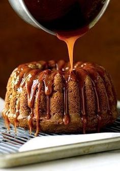 a bundt cake with caramel glaze being drizzled over it