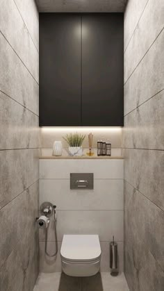 a bathroom with a white toilet sitting next to a wall mounted faucet in it