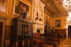 an ornately decorated room with chandeliers and paintings