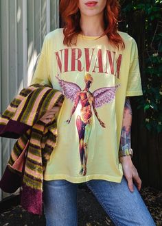 Takin' it back to 1993 with this killer Nirvana In Utero tee! Yellow Mist colorway. Super soft with a look and feel like you picked it up from the merch table in '93. This tee is Daydreamer's signature Merch tee style: intentionally oversized and meant to fit like that perfect vintage find with a perfect drape. Also available in a vintage black colorway. Features: Made from a 100% cotton fabric, feels like a luxury tour shirt with the perfect drape Roomy, oversized fit with open neck Single stit Retro Graffiti Print Tops For Concert, Band Merch T-shirt With Vintage Print For Streetwear, Yellow Grunge Tops For Streetwear, Oversized Vintage Graffiti Print Tops, Vintage Oversized Tops With Graffiti Print, Oversized Vintage Tops With Graffiti Print, Oversized T-shirt With Vintage Print For Streetwear, Oversized Vintage Print T-shirt For Streetwear, Grunge Yellow T-shirt For Streetwear