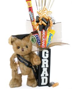 a teddy bear holding a graduation cap and candy bar