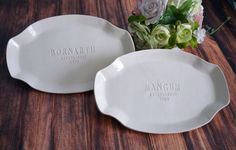 two personalized serving platters with flowers in the background