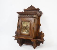 an old wooden clock with carvings on it