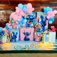 the birthday party is decorated with balloons and decorations, including an image of stitchy characters