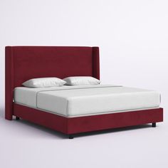 a red bed with white sheets and pillows on top of the headboard is shown in front of a gray background