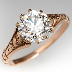 an antique style diamond ring with filigree accents