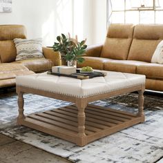 a living room with two couches, a coffee table and a rug on the floor