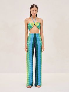 The Belgium Pant offers a range of vibrant colors giving it a unique aesthetic. These woven pants are designed with a chevron knit pattern, a wide-leg fit, and a convenient pull-on waistband. Complete the look by pairing it with the matching Annaliese top and Retti robe. Dry Clean 100% Viscose Lining:95% Polyester, 5%Spandex Bodysuit Blouse, Cami Nyc, Crop Top Sweater, Jumpsuit Shorts Rompers, Unique Aesthetic, Knit Pattern, Western Dresses, Fashion House, Twist Front