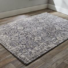 an area rug in a room with hardwood floors