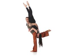 a man and woman are doing an acrobatic dance move on white background