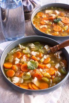 two bowls filled with soup on top of a table