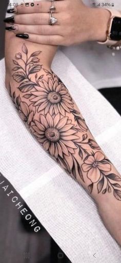 a woman's arm with flowers on it