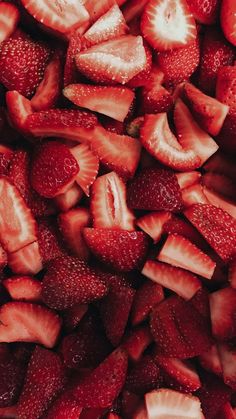 sliced strawberries are piled up in a pile