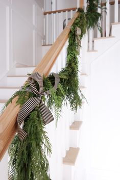 the stairs are decorated with greenery and bows