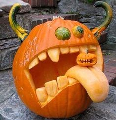 a pumpkin carved to look like a monster with its mouth open