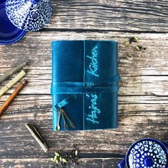 a blue wrapped gift box sitting on top of a wooden table next to other items