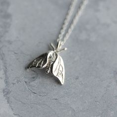 A tiny woodland moth, hand-carved and cast in sterling silver - a perfect gift for nature lovers. Moths are guided by the moon and fly fearlessly towards moonlight; wear this pendant as a symbol of your own bravery and self-belief. This delicate moth pendant hangs on an 18 inch fine silver chain. The pendant is small and delicate, dimensions are 14mm x 13mm. It can be worn alone or layered with other jewellery. Also available as a larger silver hawk moth necklace, as pictured: https://www.etsy.c Moth Pendant, Moth Necklace, Woodland Jewelry, Dope Jewelry, Rose Jewelry, Funky Jewelry, Gifts For Nature Lovers, Dream Jewelry, Pretty Jewellery