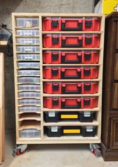 a wooden shelf filled with lots of plastic bins and drawers next to a dresser