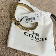 Coach. Brand New. Pegged Signature Hinged Bangle. Gold. Bangle Gold, Coach Jewelry, Coach New York, Swim Shoes, Jewelry Essentials, Adidas Track, Leather Cuffs Bracelet, Coach Accessories, Accessories Fashion