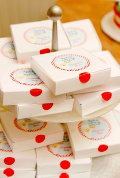 a stack of white boxes sitting on top of a table covered in red polka dots