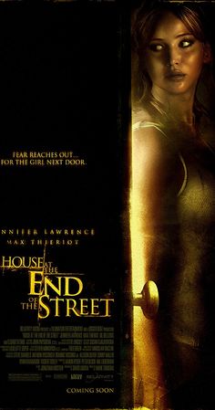 a poster for the movie house at the end of the street with a woman standing in front of it