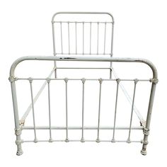 a white metal bed frame with no headboard