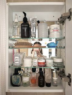 a bathroom shelf filled with lots of different types of personal care products and hygiene items