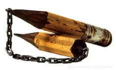 two wooden pencils chained to a metal chain