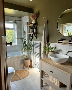 a white sink sitting under a bathroom mirror