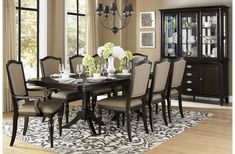 a dinning room table with chairs and a chandelier