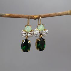 Green Swarovski Earrings, Bohemian Gemstone Earrings, Boho Earrings, Statement Jewelry, Green Earrings, Gold Filled Earrings, Boho Chic Unique and glamorous flamenco earrings features a gorgeous setting of green Swarovski set in copper bezel. With a touch of boho chic, these earrings have a lovely keshi pearl cluster and a green zircon drop.  The perfect accent to all your favorite outfits, these earrings are an elegant statement piece.  The hook is 14K gold filled. Perfect for a bride or bridesmaid. Also, these earrings are comfortable enough for every day wear! Measurements: Total length including hook: approx. 4 cm Green zircon drop: 10/14 mm Materials: Stones: green Swarovski, keshi pearls, green zircon Metal: gold filled, copper The gemstones I use are genuine and natural. Therefore, Earrings Boho Chic, Angel Earrings, Peridot Jewelry, Pearl Cluster, Green Jewelry, Earrings Bohemian, Gold Filled Earrings, Keshi Pearls, Big Earrings