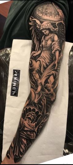 a man's arm with an angel tattoo on it