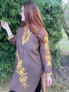 Kashmiri murti is a type of warm and comfortable maxi kurti. We are presenting this traditional garment in it's modern version handmade from cotton and silk blend and embellished with stunning Kashmiri embroidery. The embroidery is in the neckline with embroidered detail on the sleeves and borders.  Practical and comfortable, it is a practical everyday wear especially good looking with leggings. The kurti is slightly transparent as you can see on the picture and It is also perfect to throw over Fall Floral Embroidered Straight Kurta, Long Sleeve Kurta With Dabka Work For Fall, Bohemian Kurta With Resham Embroidery For Fall, Bohemian Resham Embroidered Kurta For Fall, Brown Tunic Kaftan For Spring, Spring Brown Tunic Kaftan, Bollywood Style Embroidered Long Sleeve Tunic, Brown Straight Kurta For Eid, Long Sleeve Brown Kurta For Festivals