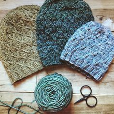 three knitted hats with scissors and yarn