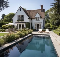 a house with a pool in front of it