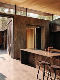 an open kitchen and dining area with stools