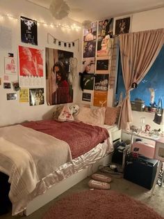 a bed room with a neatly made bed and lots of pictures on the wall above it