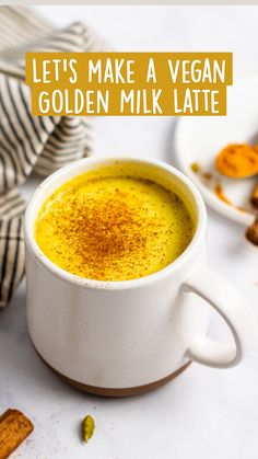 a white cup filled with golden milk and topped with cinnamon