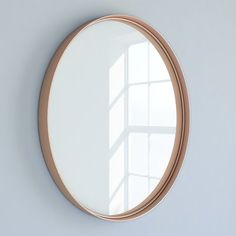 a round mirror hanging on the wall